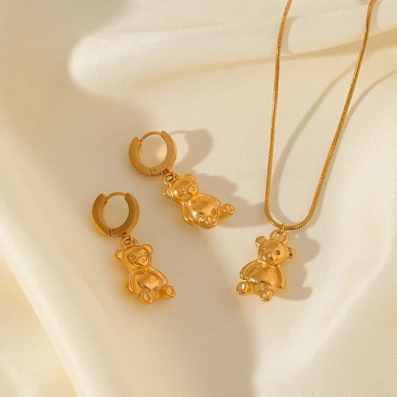 Smyckessett med halskedja och örhängen, björn och blomma, guld